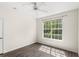 Bedroom featuring wood-look floors, ceiling fan, and a large window at 12843 Madison Pointe Cir # 106, Orlando, FL 32821