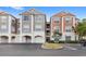 Exterior view of condo buildings with attached garages and reserved parking spaces at 12843 Madison Pointe Cir # 106, Orlando, FL 32821