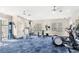Well-equipped fitness center with ample machines and natural light from the large windows at 12843 Madison Pointe Cir # 106, Orlando, FL 32821