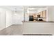 Kitchen with black appliances and view into the dining room at 12843 Madison Pointe Cir # 106, Orlando, FL 32821