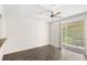 Bright living room with sliding glass doors to balcony and wood-look flooring at 12843 Madison Pointe Cir # 106, Orlando, FL 32821