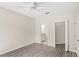 Spacious main bedroom with wood-look floors, ceiling fan, and an ensuite bathroom at 12843 Madison Pointe Cir # 106, Orlando, FL 32821