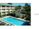 Community pool surrounded by greenary and a cabana, perfect for relaxation at 133 Oyster Bay Cir # 330, Altamonte Springs, FL 32701