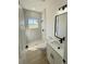 Bright bathroom with marble tiled shower, vanity with black hardware and a window at 14145 Sw 47Th Ave, Ocala, FL 34481