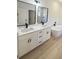 Bright bathroom features double vanity, black hardware, sleek bathtub, and a tiled shower at 14145 Sw 47Th Ave, Ocala, FL 34481