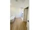 Modern bathroom featuring a soaking tub, walk-in shower, and light wood flooring at 14145 Sw 47Th Ave, Ocala, FL 34481