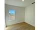 Bright bedroom with light wood floors and a large window at 14145 Sw 47Th Ave, Ocala, FL 34481