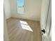 Bright bedroom with light wood-look floors, a window for natural light, and neutral paint at 14145 Sw 47Th Ave, Ocala, FL 34481