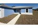 Charming single Gathering home featuring a light blue exterior and sidewalk leading to the front door at 14145 Sw 47Th Ave, Ocala, FL 34481