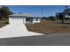 Single story home featuring a 2-car garage, light blue exterior and a concrete driveway at 14145 Sw 47Th Ave, Ocala, FL 34481