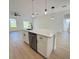 Kitchen island featuring a stainless steel dishwasher, sink, breakfast bar and pendant lighting at 14145 Sw 47Th Ave, Ocala, FL 34481