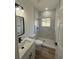 Updated bathroom featuring modern single sink vanity and a large walk in shower with a window at 15164 Sw 46Th Cir, Ocala, FL 34473