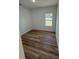 Bright bedroom with light-colored walls, wood flooring, and a window showcasing the view outside at 15164 Sw 46Th Cir, Ocala, FL 34473
