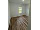A simple bedroom shows off wood-look floors and a large window for lots of natural light at 15164 Sw 46Th Cir, Ocala, FL 34473