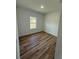 A simple bedroom shows off wood-look floors and a large window for lots of natural light at 15164 Sw 46Th Cir, Ocala, FL 34473