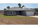 Charming one-story home featuring a gray exterior, attached garage, and well-manicured lawn at 15164 Sw 46Th Cir, Ocala, FL 34473