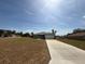 Wide view of a modern home with a long driveway and green lawn in a suburban setting at 15164 Sw 46Th Cir, Ocala, FL 34473