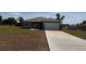 New single-story home boasts a manicured front lawn and a freshly paved driveway at 15164 Sw 46Th Cir, Ocala, FL 34473