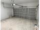 Spacious garage with gray door, concrete flooring, and ample room for parking and storage at 15164 Sw 46Th Cir, Ocala, FL 34473