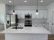 Modern kitchen featuring white cabinets, stainless steel appliances, and a large center island at 15164 Sw 46Th Cir, Ocala, FL 34473