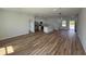 Open-concept living space with wood-look flooring, recessed lighting, and seamless flow into kitchen at 15164 Sw 46Th Cir, Ocala, FL 34473