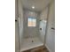 A modern shower boasts marble-look tile and black fixtures, creating a sleek, stylish space at 15164 Sw 46Th Cir, Ocala, FL 34473