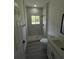 Sleek shower with white tile and black fixtures in a well-lit bathroom at 15259 Sw 51St Cir, Ocala, FL 34473