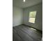 Simple bedroom with gray wood-look flooring and a bright window at 15259 Sw 51St Cir, Ocala, FL 34473