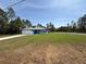 Attractive home with blue exterior, spacious front lawn, and ample space for outdoor activities at 15259 Sw 51St Cir, Ocala, FL 34473