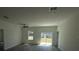 Bright living room with sliding glass doors, ceiling fan and durable wood-look flooring at 15259 Sw 51St Cir, Ocala, FL 34473
