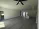 Spacious living room with wood flooring, ample natural light, and a modern ceiling fan at 15259 Sw 51St Cir, Ocala, FL 34473