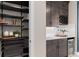 Elegant bar area with dark cabinetry, wine rack, beverage cooler, and decorative shelving at 15335 Rising View Dr, Montverde, FL 34756