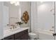 Bright bathroom featuring white tile, bronze hardware, and a modern vanity with stylish decor at 15335 Rising View Dr, Montverde, FL 34756