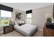 Cozy bedroom with neutral tones, a comfortable bed, and ample natural light from two windows at 15335 Rising View Dr, Montverde, FL 34756