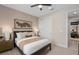Inviting bedroom with white bedding, a dark bed frame, and a minimalist aesthetic at 15335 Rising View Dr, Montverde, FL 34756