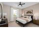 Cozy bedroom with a comfortable bed, neutral colors, and a view to the garden at 15335 Rising View Dr, Montverde, FL 34756