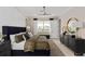 Comfortable bedroom with large window, modern lighting, and neutral tones at 15335 Rising View Dr, Montverde, FL 34756