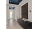 Elegant foyer showcasing a decorative console table, artwork, and a bright entryway door at 15335 Rising View Dr, Montverde, FL 34756