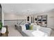 Open living area with a large sectional sofa, desk space, and modern lighting fixture at 15335 Rising View Dr, Montverde, FL 34756