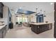 Open concept living room featuring a kitchen island, pendant lights, and access to the outdoor patio at 15335 Rising View Dr, Montverde, FL 34756
