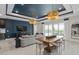 Open-concept living room featuring a dining area, comfortable seating, and access to the outdoor patio at 15335 Rising View Dr, Montverde, FL 34756