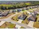 Aerial view of a neighborhood featuring well-maintained homes, manicured lawns, and lush green landscaping at 1816 Forest Glen Dr, Fruitland Park, FL 34731