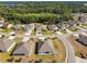 Expansive aerial view of homes in a community surrounded by lush green trees and grassy areas at 1816 Forest Glen Dr, Fruitland Park, FL 34731