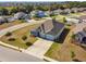 An aerial showcases a home's three-car garage, stone accents, and lush landscaping on an expansive lot at 1816 Forest Glen Dr, Fruitland Park, FL 34731