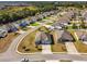 A neighborhood showcases well-maintained homes, manicured lawns, and lush landscaping in an aerial view at 1816 Forest Glen Dr, Fruitland Park, FL 34731