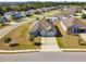 The aerial captures a home with a three-car garage, stone accents, landscaping, and a cul-de-sac street at 1816 Forest Glen Dr, Fruitland Park, FL 34731