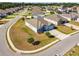 An aerial view of a home features a three-car garage, stone accents, and landscaping on a corner lot at 1816 Forest Glen Dr, Fruitland Park, FL 34731