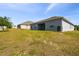 View of the backyard with a covered patio, perfect for enjoying outdoor living and entertaining at 1816 Forest Glen Dr, Fruitland Park, FL 34731