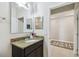 Bathroom featuring dark wood cabinet with granite countertop and large mirror at 1816 Forest Glen Dr, Fruitland Park, FL 34731
