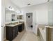 This spacious bathroom features a granite countertop, double sinks, and a large soaking tub and shower at 1816 Forest Glen Dr, Fruitland Park, FL 34731